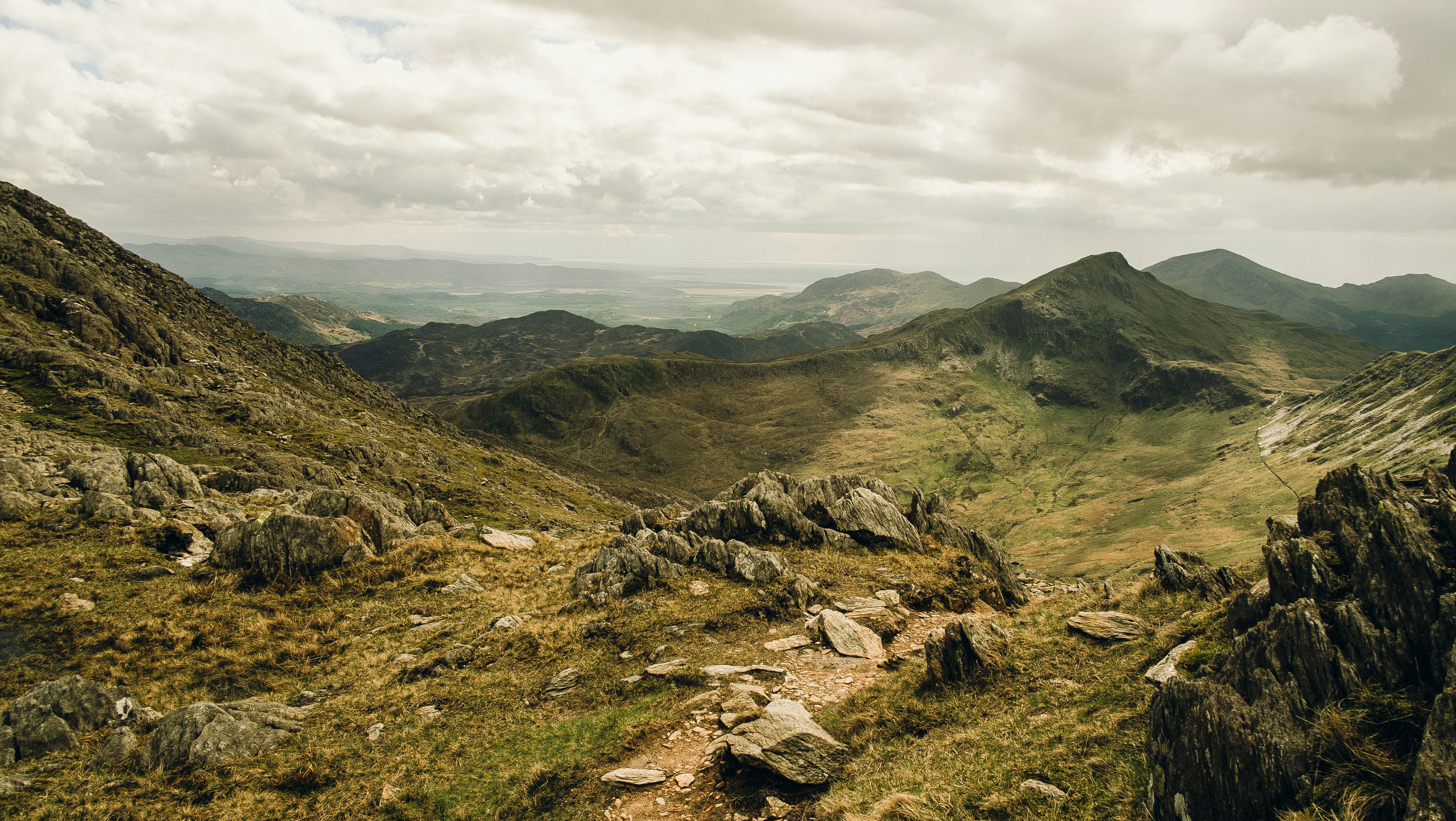 View down a misty Welsh mountain valley toward the sea